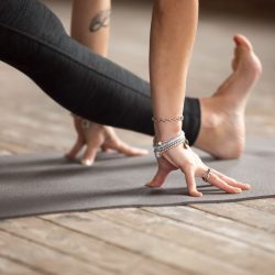 Yoga class practicing forward Bends & Splits